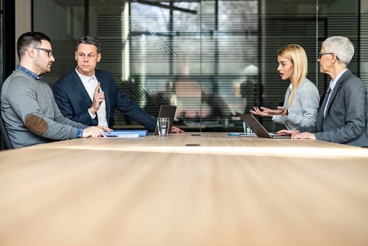 A group of people sitting at a table

AI-generated content may be incorrect.